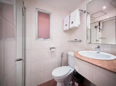a bathroom with a toilet and a sink at KC Place Hotel Pratunam in Bangkok
