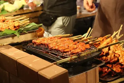 a grill with many different types of food on it at KC Place Hotel Pratunam in Bangkok