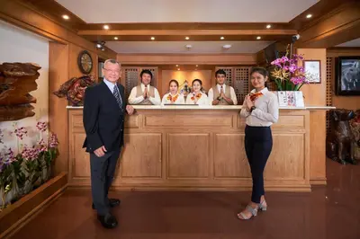 a man and a woman standing in front of a bar at KC Place Hotel Pratunam in Bangkok
