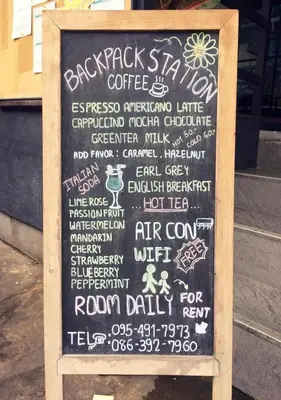 a chalkboard sign with a menu for a restaurant at Backpack Station in Bangkok