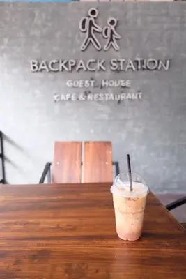 a drink sitting on top of a wooden table at Backpack Station in Bangkok