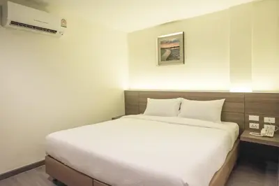 a large white bed in a hotel room at Sovereign Group Hotel at Pratunam in Bangkok