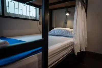 a bedroom with two bunk beds and a window at Dreamcatcher Bangkok in Bangkok