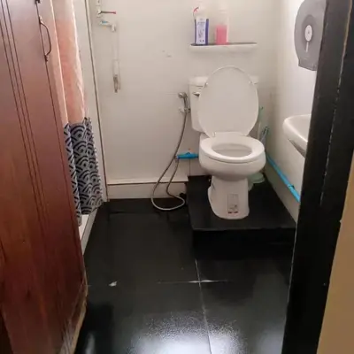 a small bathroom with a toilet and a sink at Dreamcatcher Bangkok in Bangkok