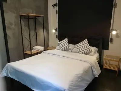 a bedroom with a large bed with white sheets and pillows at Dreamcatcher Bangkok in Bangkok