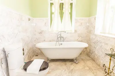 a white bathroom with a sink and a toilet at Baan 2459 Heritage House in Bangkok