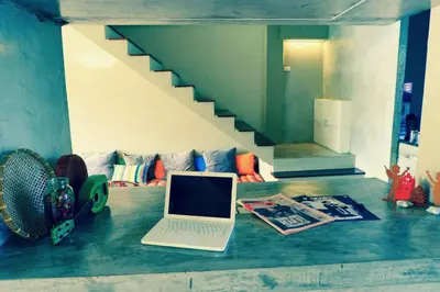 a laptop computer sitting on the floor in a living room at Home'81 in Bangkok