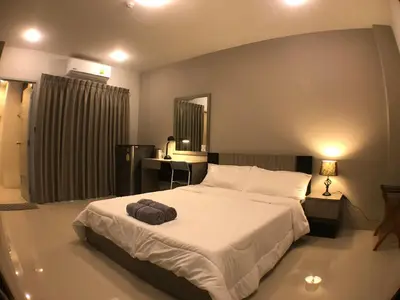 a bedroom with a bed with a bag on it at 28 Place in Bangkok