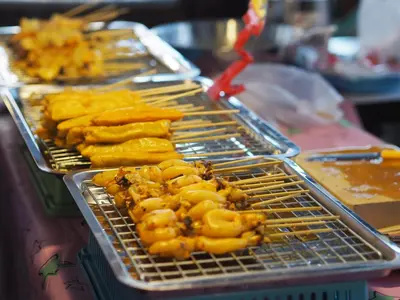 a metal grill with some food on it at 28 Place in Bangkok