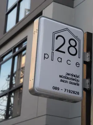 a sign on the side of a building at 28 Place in Bangkok