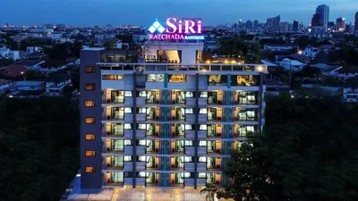 a building with a sign on top of it at SiRi Ratchada Bangkok in Bangkok