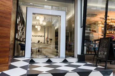 a store front with a checkered floor and a store window at The Connex Asoke in Bangkok