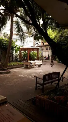 a park with two benches and a pavilion at Lamphuhouse Bangkok in Bangkok