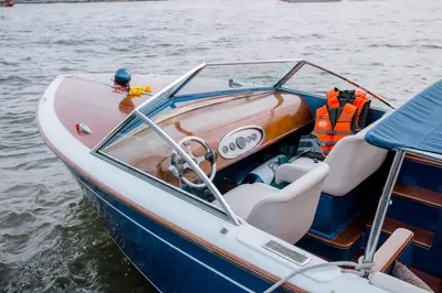 a blue and white boat on the water at Chakrabongse Villas in Bangkok