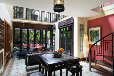 a living room with a piano in a house at Chakrabongse Villas in Bangkok