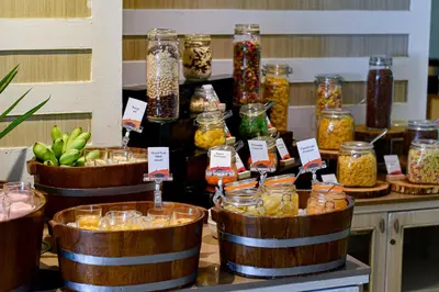 a display of jars of food on a table at Hilton Garden Inn Bangkok Silom in Bangkok