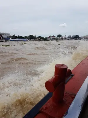 a boat in a body of water with waves at S.E.T Thanmongkol Residence in Bangkok