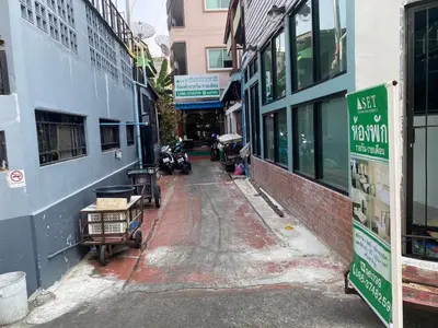 an empty street in an alley between two buildings at S.E.T Thanmongkol Residence in Bangkok