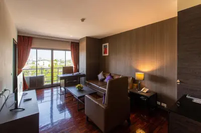 a living room with a couch and a table at Mida Hotel Don Mueang Airport in Bangkok