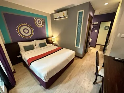 a bedroom with a large bed in a room at Sawasdee Hotel @ Sukhumvit Soi 8 in Bangkok
