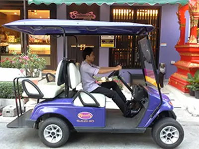 a man sitting in a golf cart at Sawasdee Hotel @ Sukhumvit Soi 8 in Bangkok