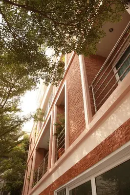 a brick building with balconies on the side of it at Mirth Sathorn Hotel in Bangkok