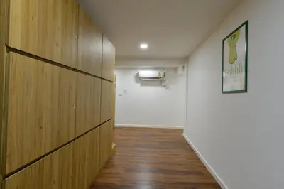 a hallway with a wooden wall and a white door at iCheck inn Sukhumvit 19 in Bangkok