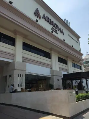 a man sitting in front of a building at Arnoma Hotel Bangkok in Bangkok