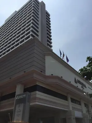 a hotel with two flags on top of a building at Arnoma Hotel Bangkok in Bangkok