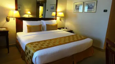 a bedroom with a large bed in a hotel room at Arnoma Hotel Bangkok in Bangkok
