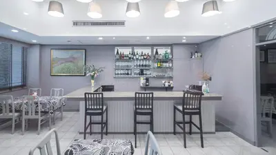 a restaurant with a bar with chairs and tables at Yellow Ribbon Hills Boutique Suites in Bangkok