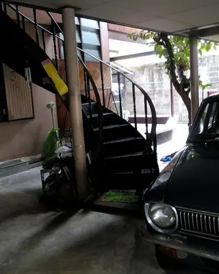 a set of stairs in a garage with a car at Anurak Guesthouse in Bangkok