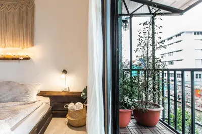 a bedroom with a balcony with potted plants at Klong House in Bangkok