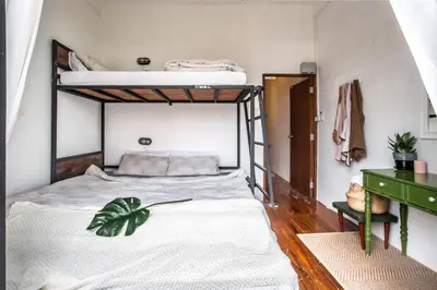 a bedroom with two bunk beds and a desk at Klong House in Bangkok