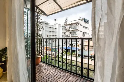 a balcony with a view of a building at Klong House in Bangkok