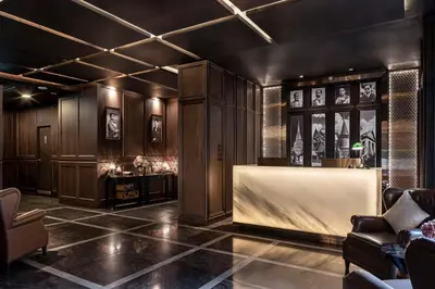 a lobby with wood paneling and a reception desk at Metropolis Suites Bangkok, Tapestry Collection by Hilton in Bangkok