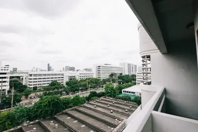 a view of the city from the balcony of a building at Baan Pratoom in Bangkok