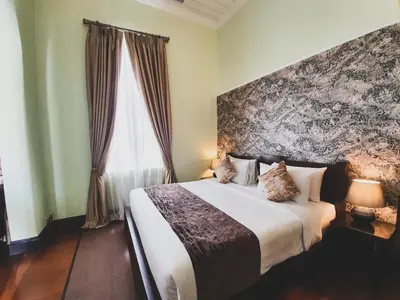 a bedroom with a bed and a large window at Praya Palazzo in Bangkok