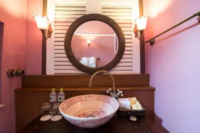 a bathroom with a sink and a mirror at Praya Palazzo in Bangkok