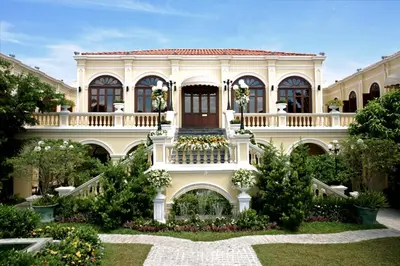 a large house with a balcony and a yard at Praya Palazzo in Bangkok