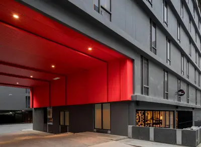 a red facade of a building at Travelodge Sukhumvit 11 in Bangkok