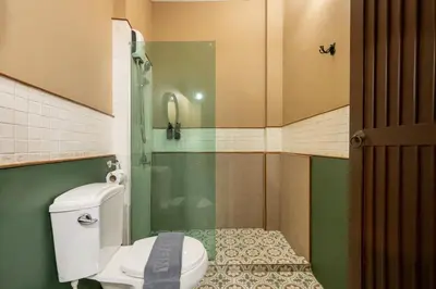 a small bathroom with a toilet and a shower at Arun Sa Wad 103 NaNa in Bangkok