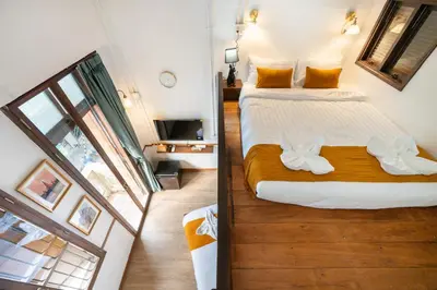 a bedroom with a large bed and a window at Arun Sa Wad 103 NaNa in Bangkok