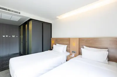 two beds sitting next to each other in a bedroom at STAY Hotel BKK in Bangkok