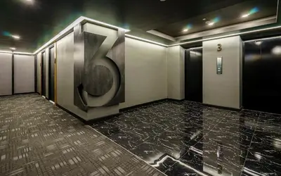 a elevator room with a large number six on the wall at STAY Hotel BKK in Bangkok