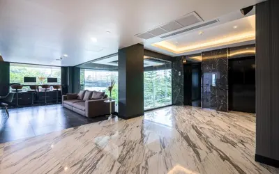 an office lobby with a couch and a table at STAY Hotel BKK in Bangkok