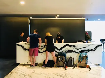 a group of people standing around a counter at STAY Hotel BKK in Bangkok
