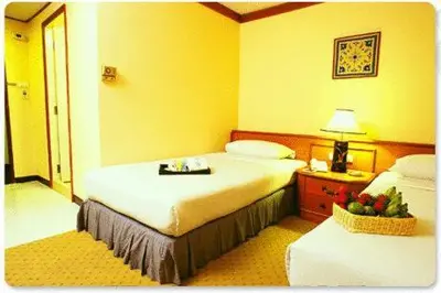 a hotel room with a bed with a tray on it at Wall Street Inn, Bangkok in Bangkok