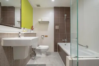a bathroom with a sink and a toilet and a shower at Hotel De Bangkok in Bangkok