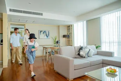 a group of people walking through a living room at Shama Petchburi 47 Bangkok in Bangkok